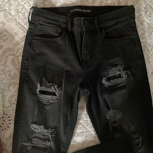 Black express jeans with sequin and distressed details.